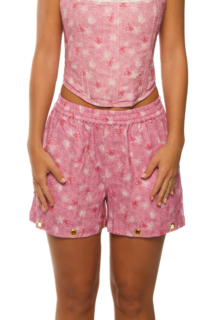 Pink linen shorts with floral pattern made for women.